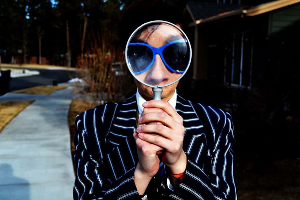woman looking through magnifying glass