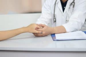doctor holding hand of a patient