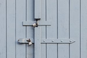 two steel locks on a wooden door
