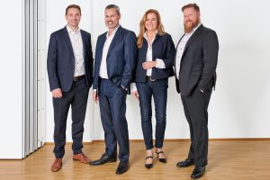 Group photo of management board of OTRS AG (from left to right: Benjamin Müller (CTO), André Mindermann (CEO), Sabine Riedel (CHRO & CMO), Christopher Kuhn (COO)